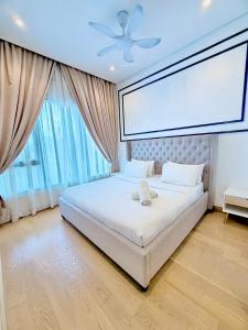 a large white bed in a room with a large window at Lucentia residence luxury suites in Kuala Lumpur +81 photos