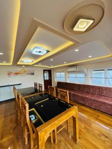 a room with a pool table and a couch at Marari houseboat in Mararikulam +119 photos