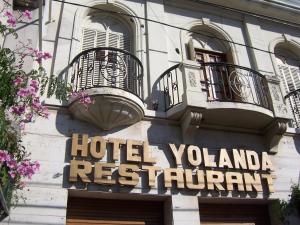 
a building with a sign on the front of it at Cordoba Yolanda Hotel in Córdoba
