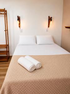 two beds in a room with two towels on the bed at Maruá Pousada da Lagoa in Jijoca de Jericoacoara +17 photos