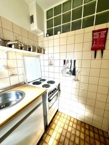 a small kitchen with a sink and a stove at Cozy cottage in Lichtenau