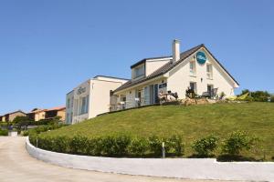 a house sitting on top of a grassy hill at Alima Surf & Hotel in Ajo