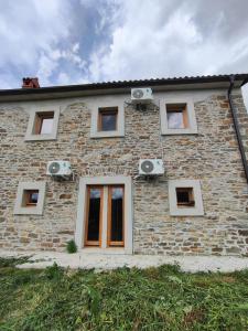 a brick house with speakers on the side of it at Roman Paradise Villa with Pool in Koper