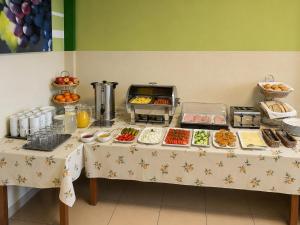a table with a buffet of food on it at Pokoje & Bistro Mielec in Mielec