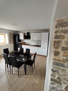 a dining room with a table and chairs and a kitchen at Roman Paradise Villa with Pool in Koper