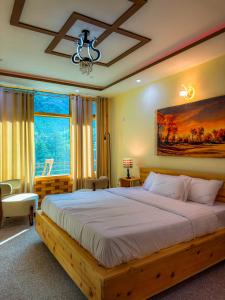 a bedroom with a large bed and a large window at Gems Palace Hotel Naltar in Jugut