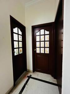 an empty room with two doors and a window at U K I Guest House in Bangalore
