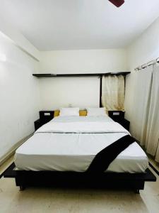 a bedroom with a large bed in a room at U K I Guest House in Bangalore
