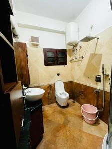 a bathroom with a toilet and a sink at U K I Guest House in Bangalore