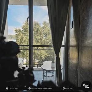 a room with a large window with a table in front of it at Cloud&Rey Rentals in Roxas City