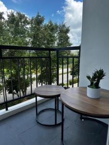 a balcony with two tables and a balcony with a view at Cloud&Rey Rentals in Roxas City