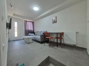 a living room with a couch and a table and chairs at Nektarioss in Kernen