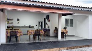 a dining room with tables and chairs on a patio at Pousada Moaçara in Estivado