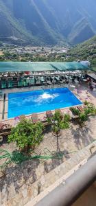 Draufsicht auf ein Schwimmbad mit Bergen im Hintergrund in der Unterkunft Hotel Vela Mare in Borsh