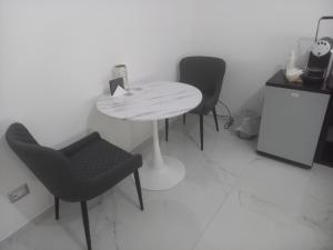 a white table and chairs in a room at BEB LA Perla in Sammichele di Bari +10 photos