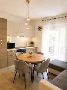 a kitchen and dining room with a table and chairs at Apartment Ivan in Marina