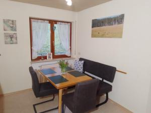 a dining room with a table and chairs and a window at Apartment in Hofstetten surrounded by nature in Hofstetten