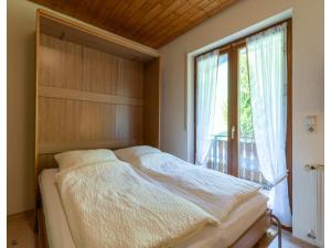 a bedroom with a bed and a large window at Apartment in Hofstetten surrounded by nature in Hofstetten