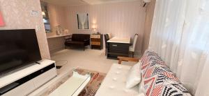 a living room with a white couch and a desk at guesthouse嵐 in Osaka