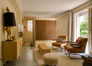 a living room with two chairs and a table at Monte Pino in Pergola