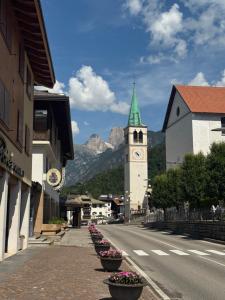 a town with a clock tower and a street at Mansarda al Lago Casa Lavaredo in Auronzo di Cadore