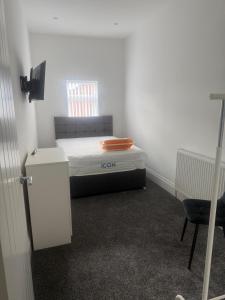 a small room with a bed and a desk at Nest in Northumberland 2 in Blythe