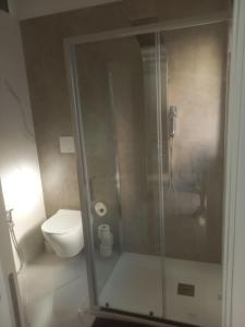 a bathroom with a toilet and a glass shower at BEB LA Perla in Sammichele di Bari