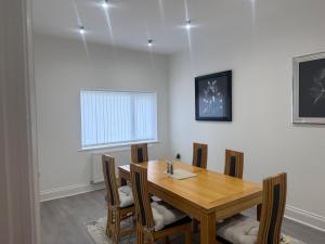 a dining room with a wooden table and chairs at Nest in Northumberland 2 in Blythe