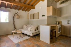a kitchen and a living room with a couch and a table at Monte Pino in Pergola
