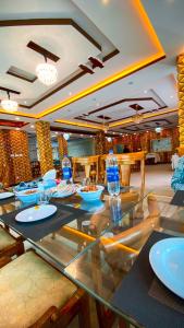 a dining room with a glass table and chairs at Gems Palace Hotel Naltar in Jugut