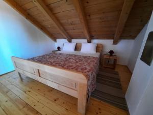 a bedroom with a large bed in a room with wooden floors at Soba Gallo in Latin