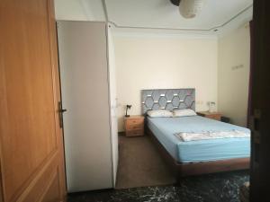 a bedroom with a bed and a door to a room at Younes residence in Asilah