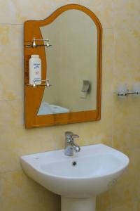 a white sink in a bathroom with a mirror at standalone in Fort Portal +5 photos