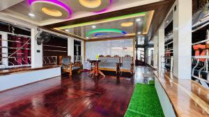 a dining room with a table and a rainbow on the wall at Marari houseboat in Mararikulam
