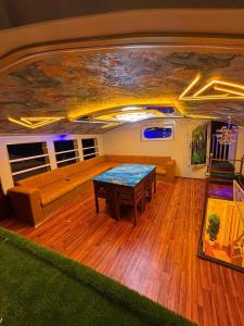 a living room with a table and a couch at Marari houseboat in Mararikulam