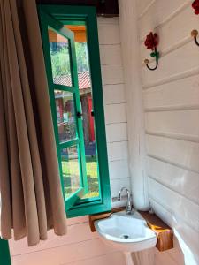 a bathroom with a sink and a window at Linha Nova Glamping in Gramado