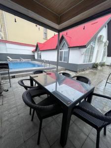 a patio with a table and chairs and a pool at Gabala Home in Gabala