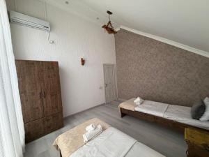 a bedroom with two beds in a room at Gabala Home in Gabala +1 photo
