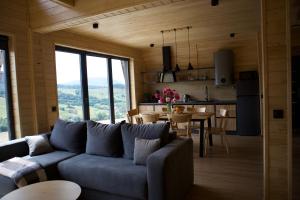 a living room with a couch and a dining room at Barnhouse VOLOVETS in Volovets