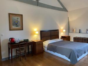 a bedroom with a bed and a desk and a bed and a desk at Domaine du Chesne in Salbris +88 photos