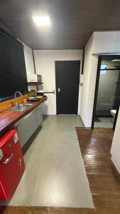 an empty kitchen with a sink and a door at Forest in Domingos Martins