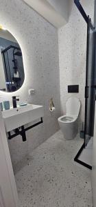 a bathroom with a toilet and a sink and a mirror at Blu Marine Loano -Terrazza Vista Mare- in Loano +15 photos