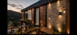 a house with lights on the side of it at Forest in Domingos Martins +16 photos