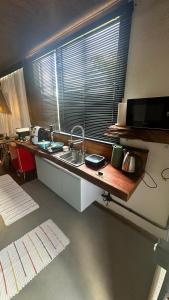 a kitchen with a counter with a sink and a window at Forest in Domingos Martins