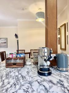 a kitchen counter with a blender on a table at The Castle Front Nest in Inverness