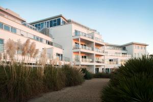 an apartment building with a pathway in front of it at St Moritz Hotel and Cowshed Spa in Polzeath