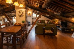 a living room with a table and a couch at Cal Gironell in Santa María de Meyá