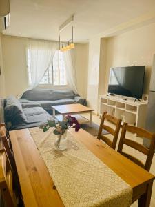 a living room with a table and a tv at Islane Holiday Studio with pool&balcony in Agadir