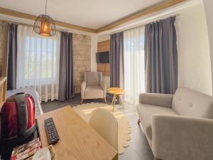 a living room with a couch and a table at The ABC Hotel in Alaçatı