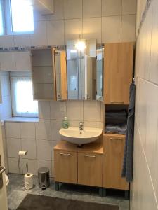 a bathroom with a sink and a mirror at Ruhrpott Liebe in Herten +12 photos